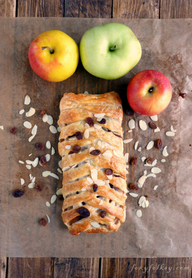 Try this easy recipe for apple strudel that is done in a few minutes. Tart apples, raisins, nuts and cinnamon baked in a light, flaky, crispy puff pastry. | www.foxyfolksy.com