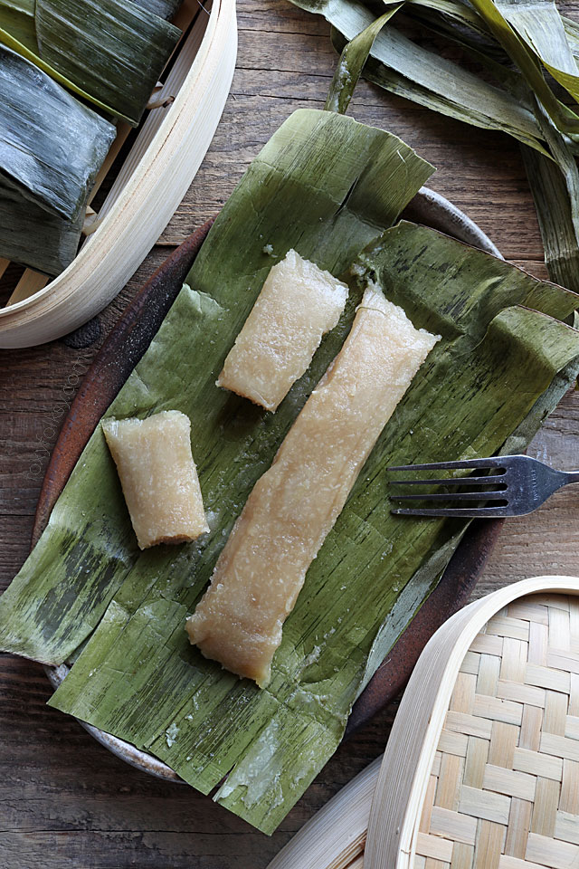 Cassava Suman is a Filipino delicacy of steaming a mixture of grated cassava, coconut milk, and sugar in banana leaves. Try this great Cassava recipe now! | www.foxyfolksy.com