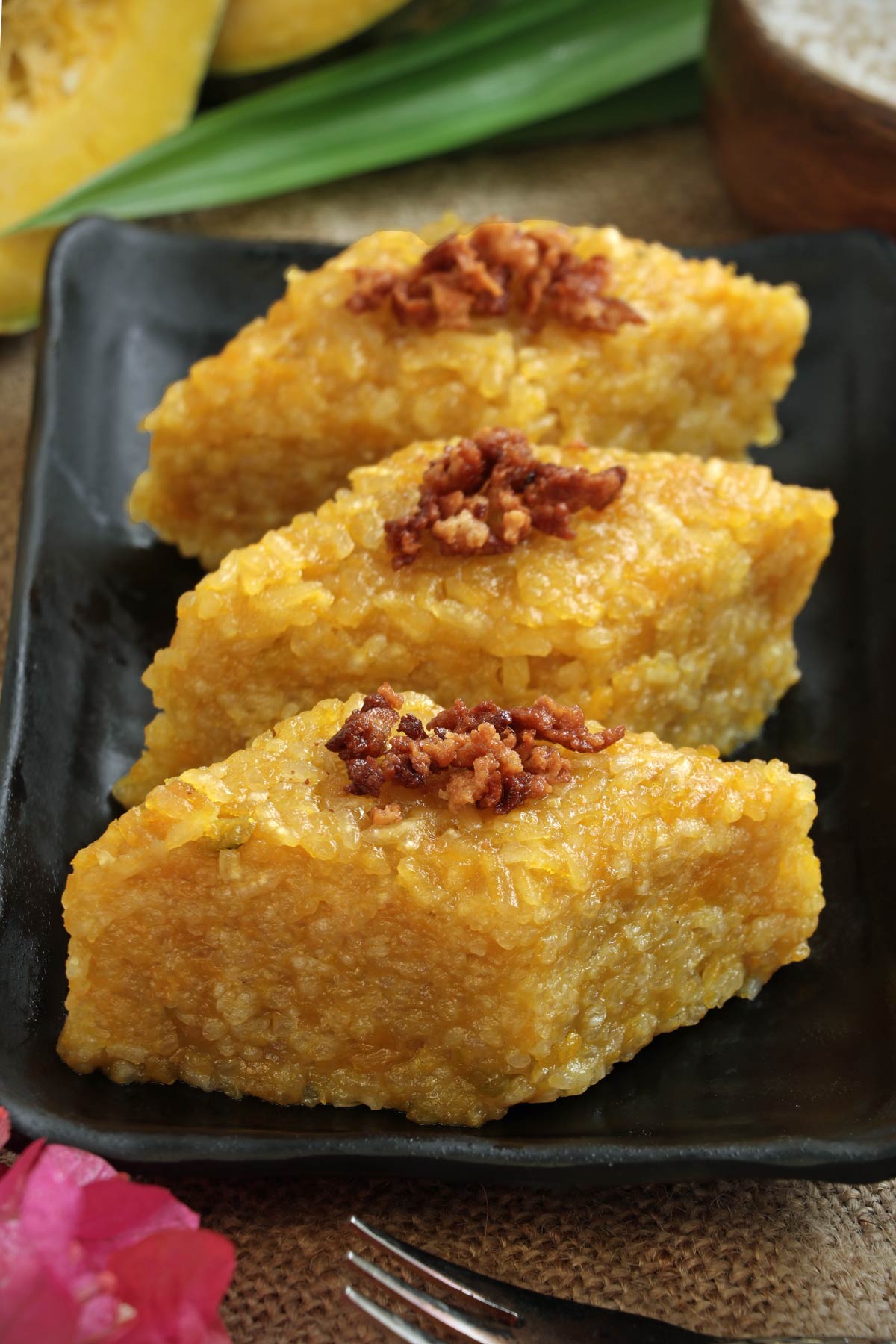 Biko Kalabasa or Sticky Rice Cake with squash cut into squares for serving.