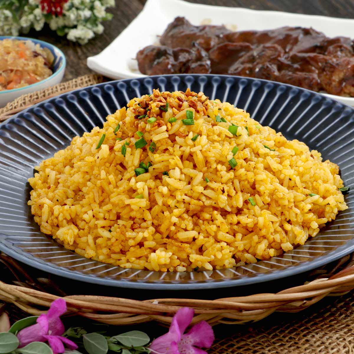 Vibrant yellow and flavorful fried rice on a plate.