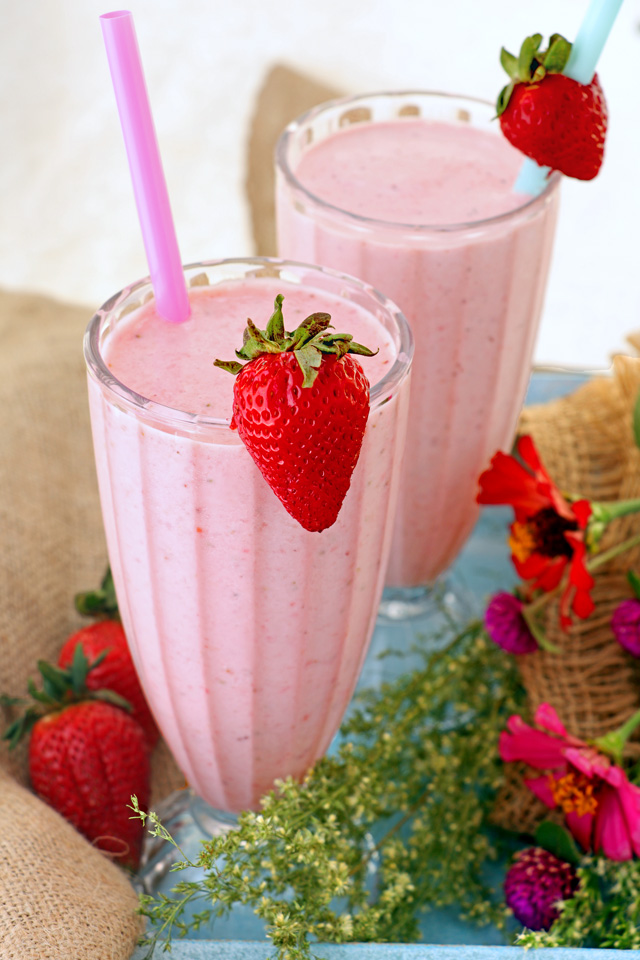 Strawberry smoothie with fresh strawberries in tall glasses