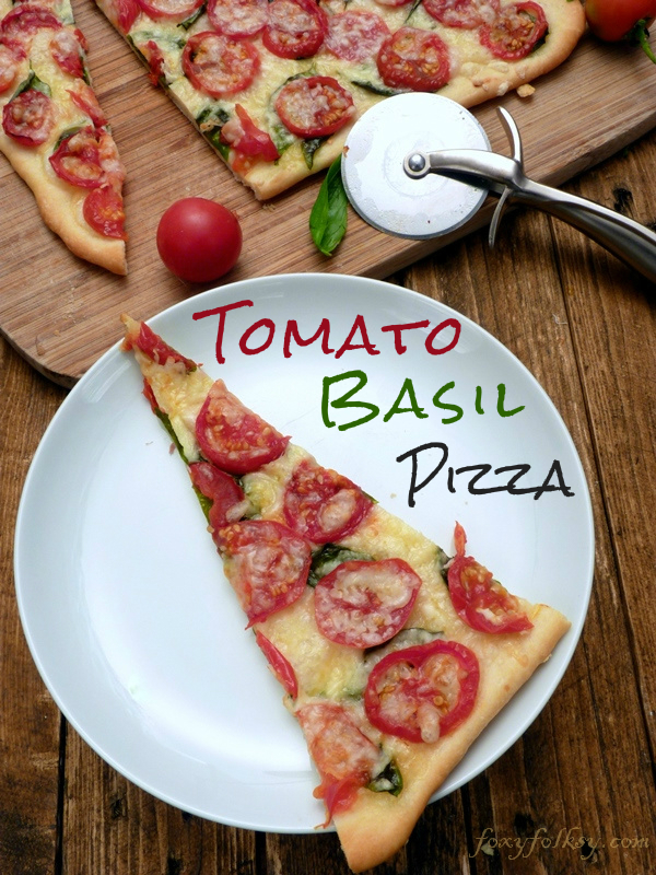 I never thought such a simple and meatless pizza could taste this good! With four basic ingredients, tomato, basil, olive oil and cheese on top of a homemade thin crust pizza dough! | www.foxyfolksy.com