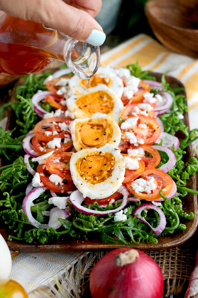 Fiddlehead Fern Salad with tomatoes, onions, salted egg and sweet vinegar dressing.