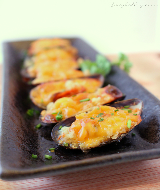 Looking for a recipe for mussels? Try this Cheesy Baked Mussels that are perfect appetizers and it is so easy to prepare too. Butter, garlic and cheese make it so delightful. | www.foxyfolksy.com 