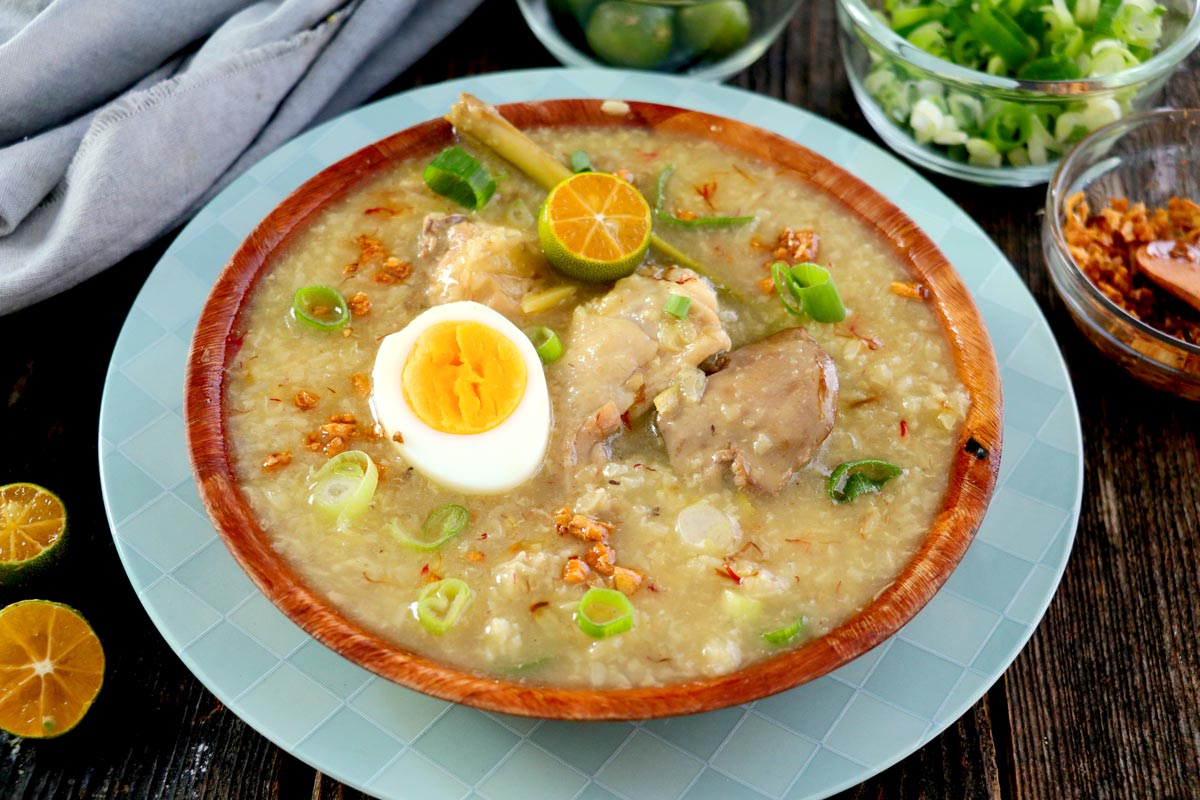 Filipino Arroz Caldo made from glutinous rice, chicken, ginger, lemongrass with hard-boiled egg and brown garlic toppings