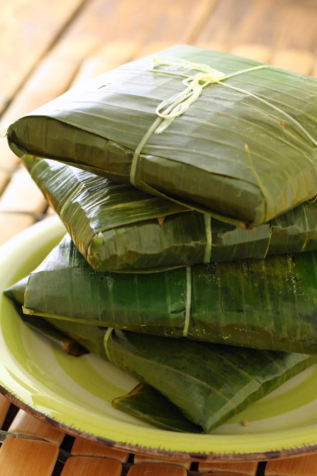 Tamales wrapped in banana leaves