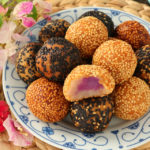 Fried glutinous rice balls with filling covered in sesame seeds