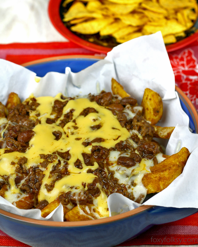 Try this meaty, very cheesy and slightly spicy Chili Cheese Fries or Potato Wedges. It is so easy to make and is done in a jiffy. | www.foxyfolksy.com