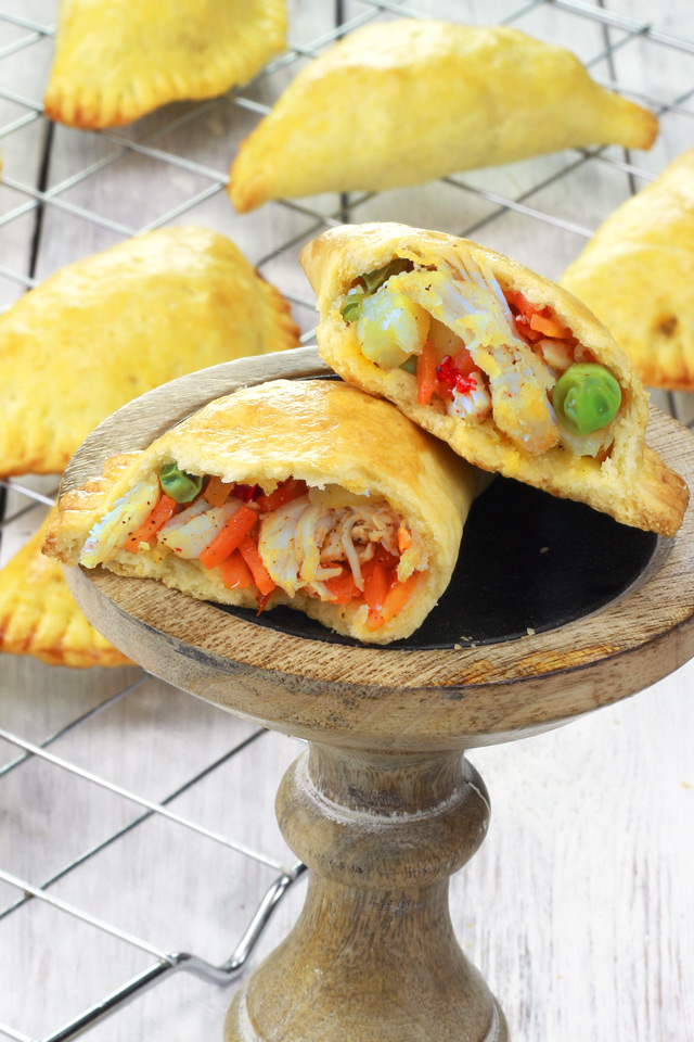 Baked Empanadas with shredded chicken, green peas, potatoes, carrots and onions in flaky crust