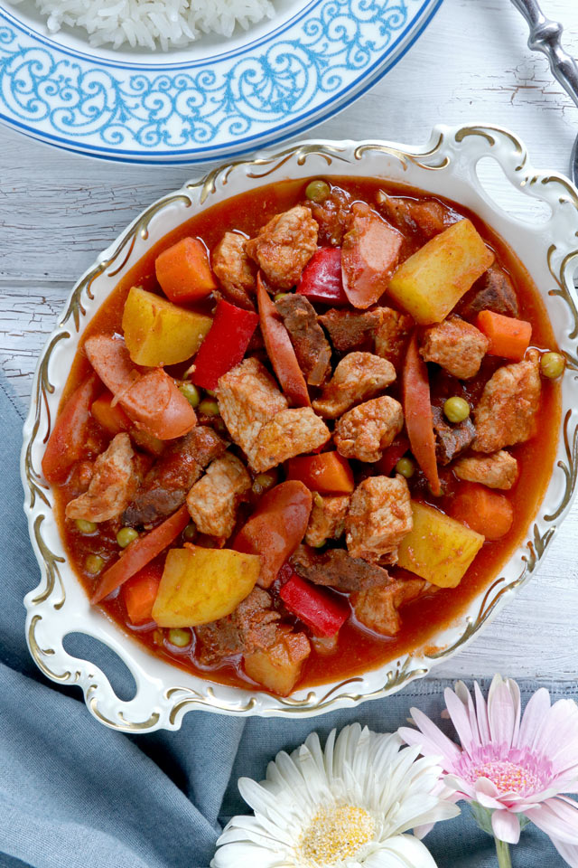 Tomato-based pork stew on a serving dish.