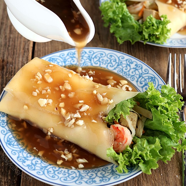 Get this recipe for Lumpiang Sariwa. A kind of Filipino Spring Rolls that is filled with various vegetables, sweet potato, shrimps and meat. Wrapped in a crepe-like wrapper and covered with a special sweet savory sauce. |www.foxyfolksy.com