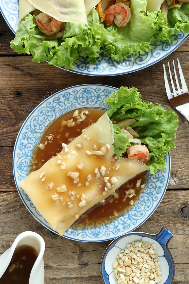 Get this recipe for Lumpiang Sariwa. A kind of Filipino Spring Rolls that is filled with various vegetables, sweet potato, shrimps and meat. Wrapped in a crepe-like wrapper and covered with a special sweet savory sauce. |www.foxyfolksy.com