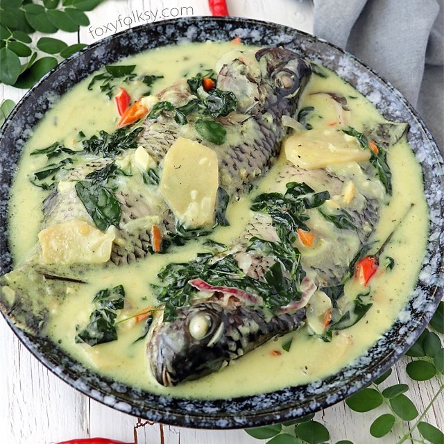 Try this creamy and spicy, Ginataang Tilapia (Tilapia in coconut milk) recipe. All done in less than 15 minutes! | www.foxyfolksy.com