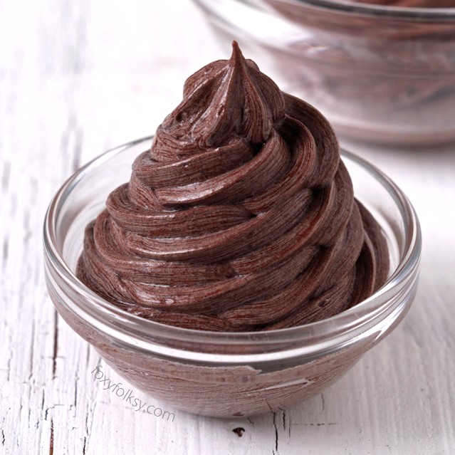 Try this Chocolate Buttercream Frosting. No powdered sugar needed. It is so light and fluffy and smoother than the classic American Buttercream Frosting. It is a bit more work but definitely easier than Swiss Meringue Frosting. It is easily the best buttercream frosting I've tried. | www.foxyfolksy.com