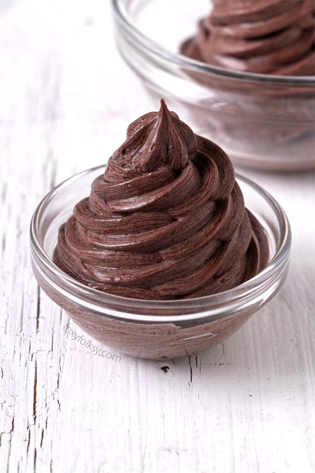 Try this Chocolate Buttercream Frosting. No powdered sugar needed. It is so light and fluffy and smoother than the classic American Buttercream Frosting. It is a bit more work but definitely easier than Swiss Meringue Frosting. It is easily the best buttercream frosting I've tried. | www.foxyfolksy.com