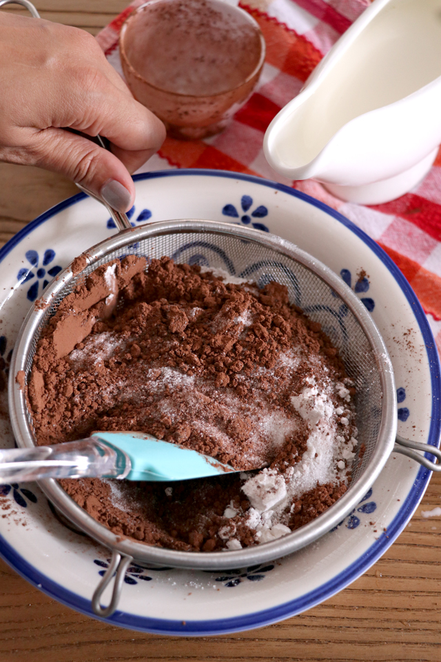 Try this Chocolate Buttercream Frosting. No powdered sugar needed. It is so light and fluffy and smoother than the classic American Buttercream Frosting. It is a bit more work but definitely easier than Swiss Meringue Frosting. It is easily the best buttercream frosting I've tried. | www.foxyfolksy.com