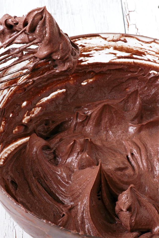 Try this Chocolate Buttercream Frosting. No powdered sugar needed. It is so light and fluffy and smoother than the classic American Buttercream Frosting. It is a bit more work but definitely easier than Swiss Meringue Frosting. It is easily the best buttercream frosting I've tried. | www.foxyfolksy.com