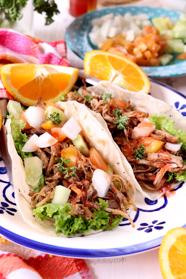 Bring your taco nights to the next level with this Pork Carnitas Tacos recipe. Soft, freshly made tortillas and savory, spicy Pork Carnitas, combined with your favorite taco veggies. Delicious! | www.foxyfolksy.com