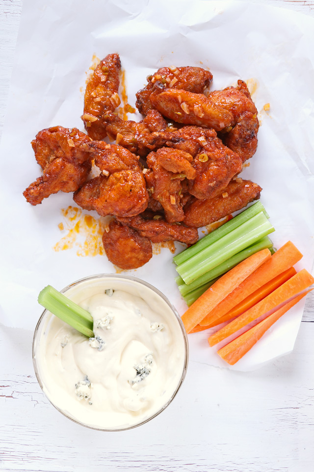 crispy fried buffalo wings with dip and celery and carrot sticks