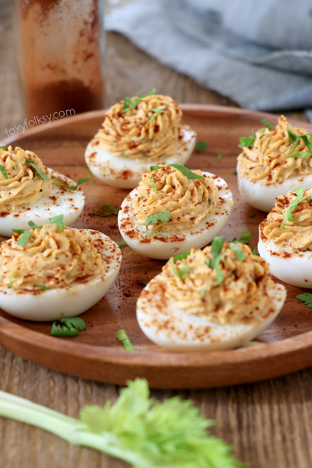 Deviled eggs with relish  on a wood plate
