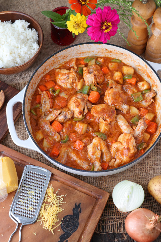 Chicken stewed in tomato sauce with carrots, potatoes, and bell pepper.