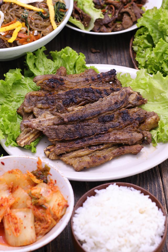 Korean BBQ Short Ribs or Galbi served on a plate with side dishes