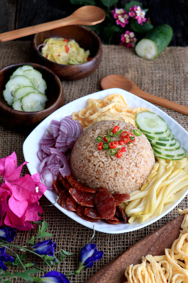 Thai Rice with shrimp paste and sides: green mango, red onions, shredded omelette, cucumber and Chinese sausage