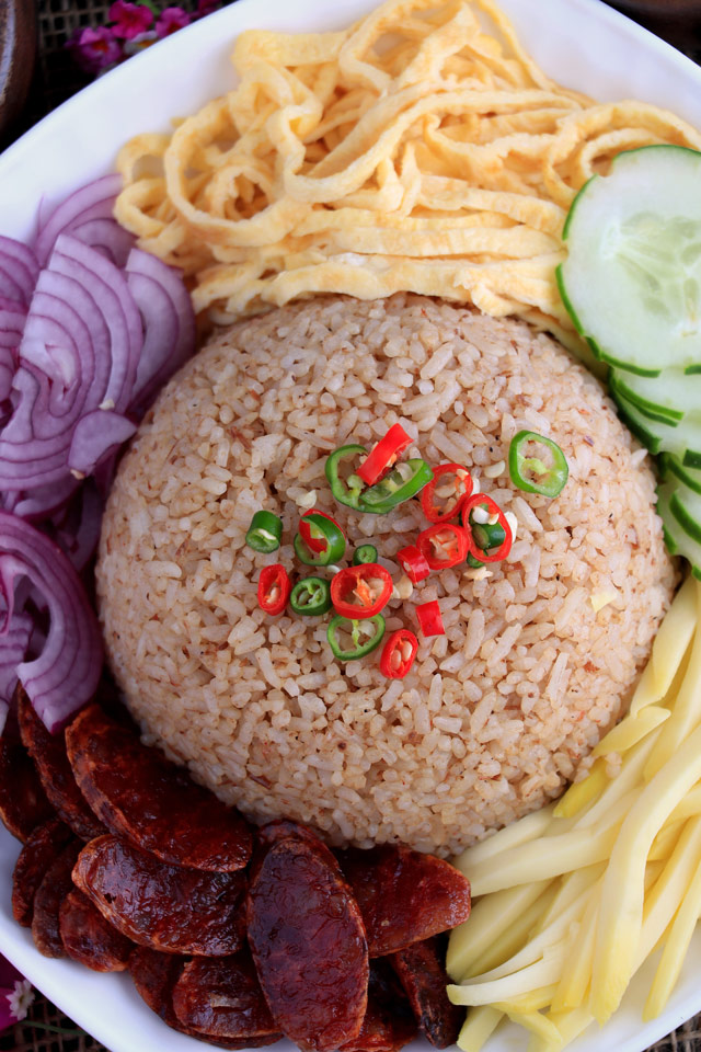 Thai Rice with shrimp paste and sides: green mango, red onions, egg, cucumber and Chinese sausage