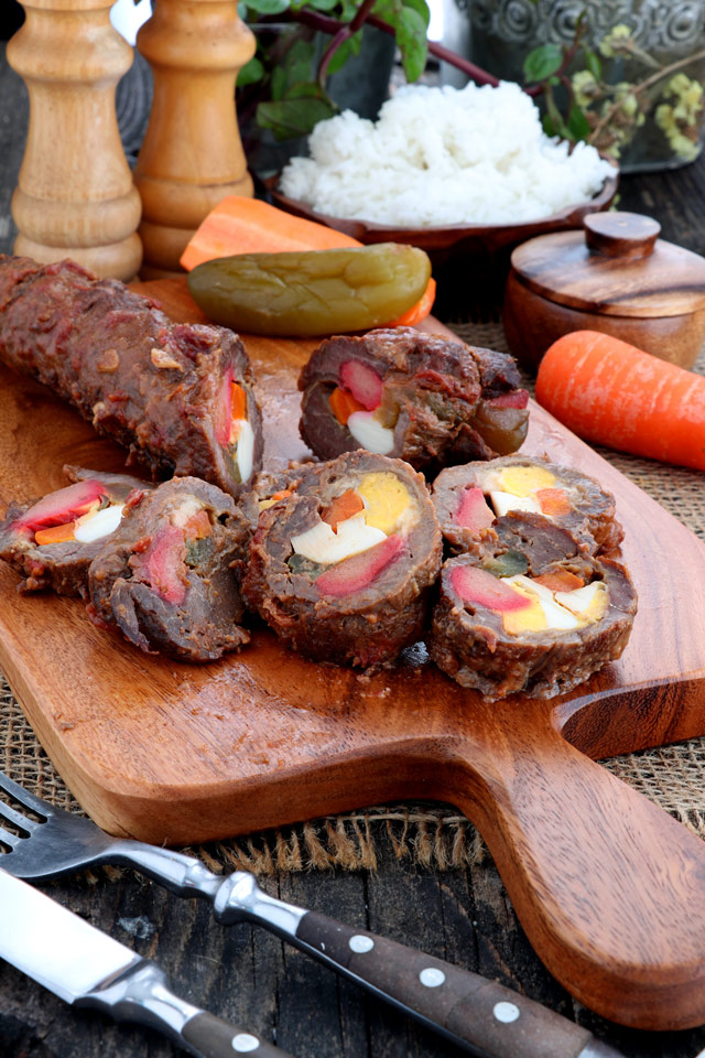 Morcon - beef roll stuffed with hard-boiled egg, pickle, carrots and cheese