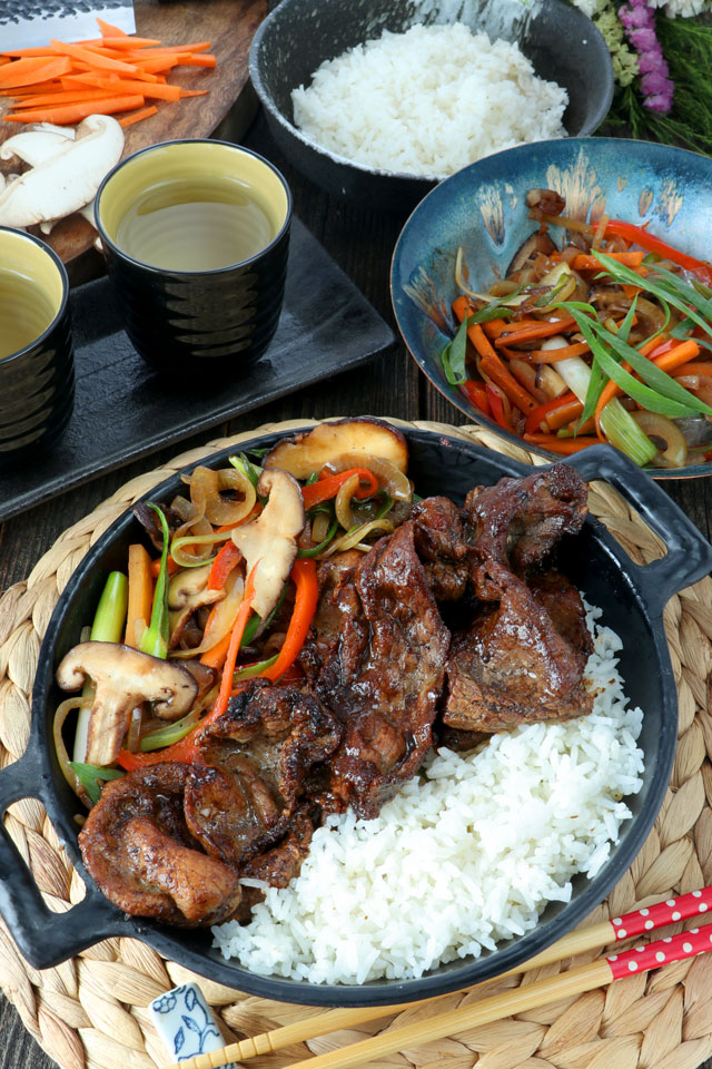 Grilled beef slices serve on a bowl with stir-fried vegetables and rice.