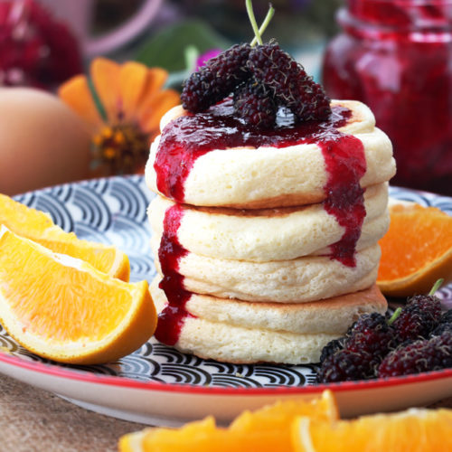 Fluffy pancakes with jam and fruits