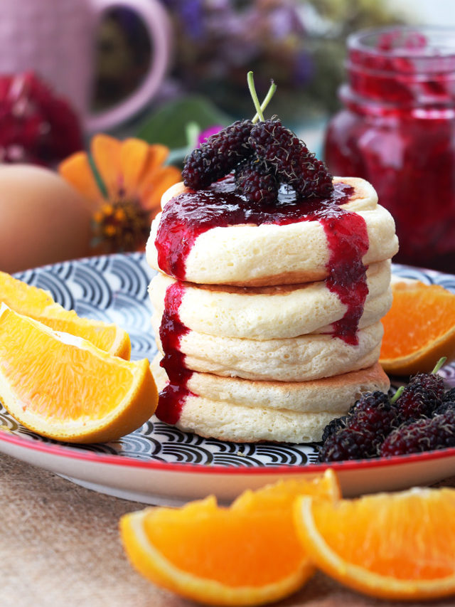 Fluffy pancakes with jam and fruits