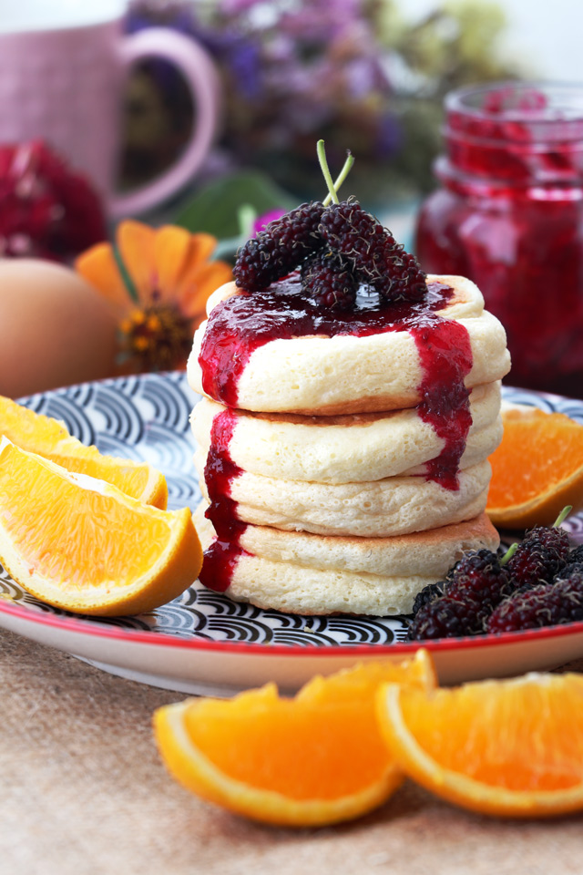 Fluffy pancakes with jam and fruits