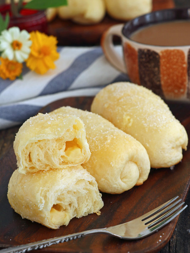 Super soft, sweet rolls with cheese filling coated with butter and sugar.