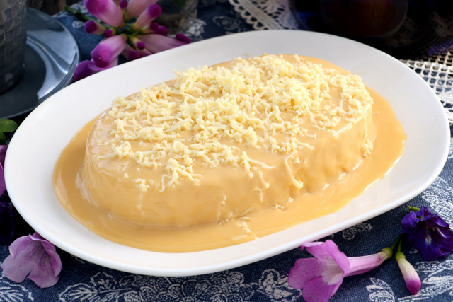 Chiffon Cake covered with yema sauce and topped with grated cheese. 