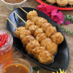 Homemade fish balls on sticks fried and dipped in special Manong's sauce.