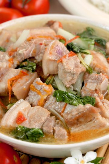 Pork soup with tomatoes and bok choy.