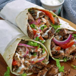 Chicken Shawarma with tomatoes, onions, lettuce and yougurt-garlic sauce.