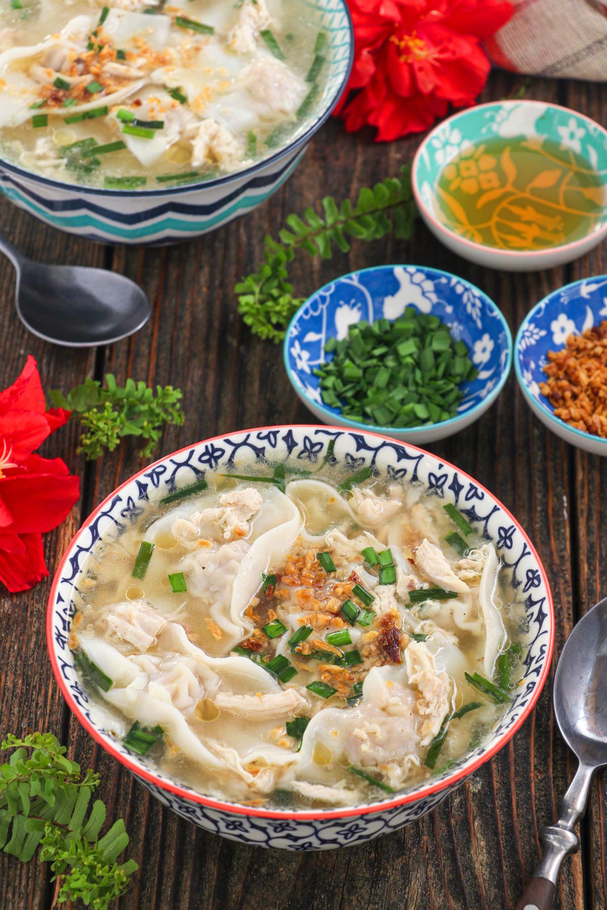 Bowls of warm pancit molo with green onions and toasted garlic. 