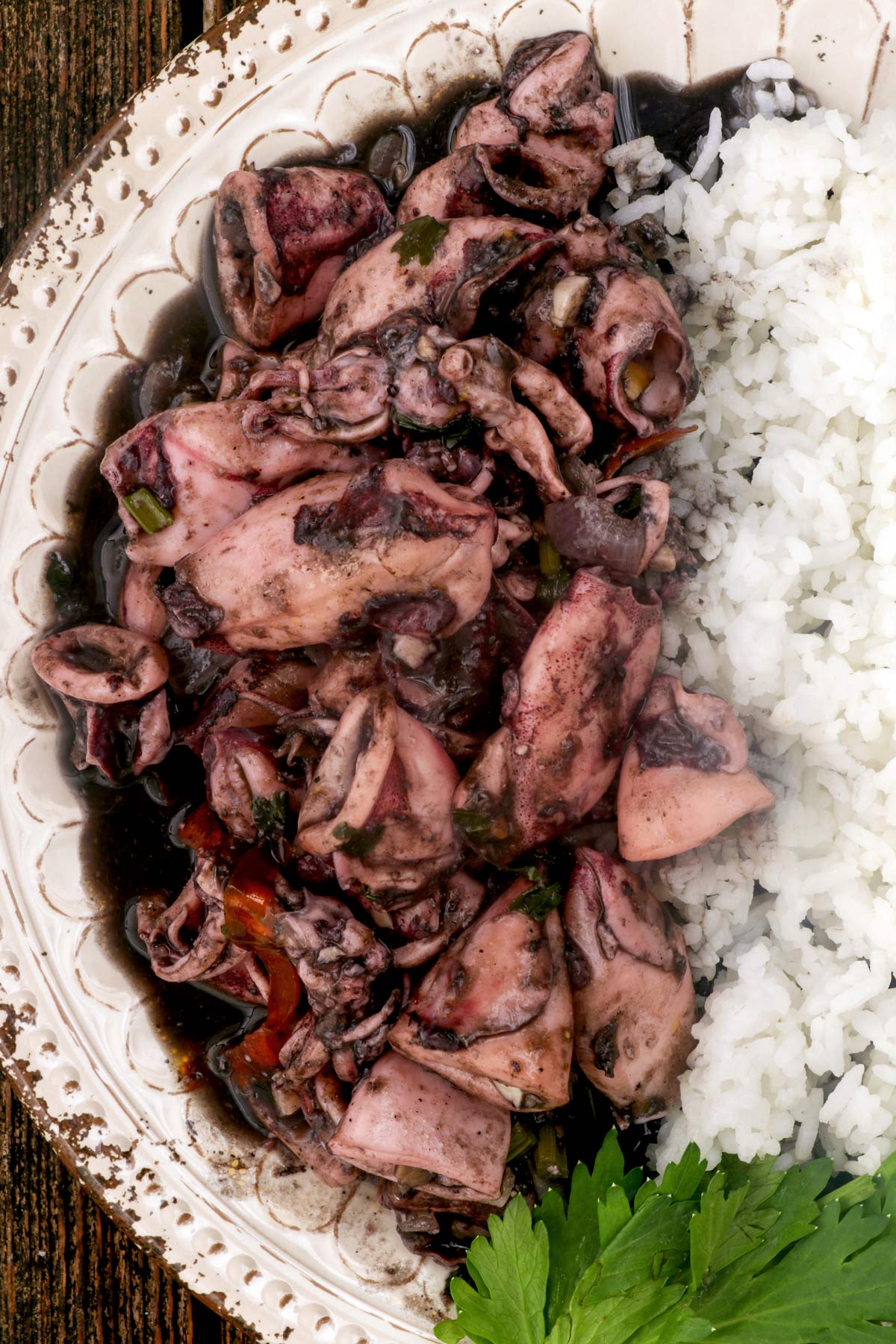 Abobong pusit in a plate served with steamed white rice.