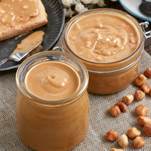 Chunky or smooth creamy homemade Peanut Butter in jars.
