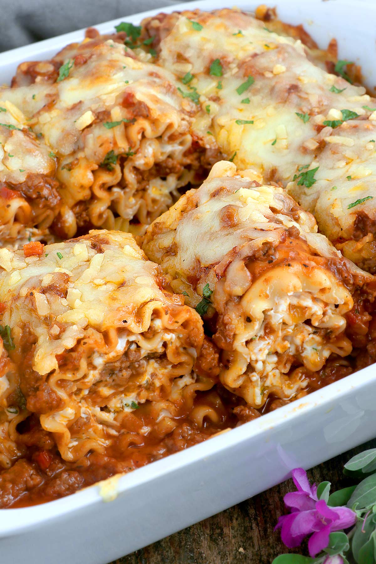 Lasagna rolled up with meat sauce and cheese.