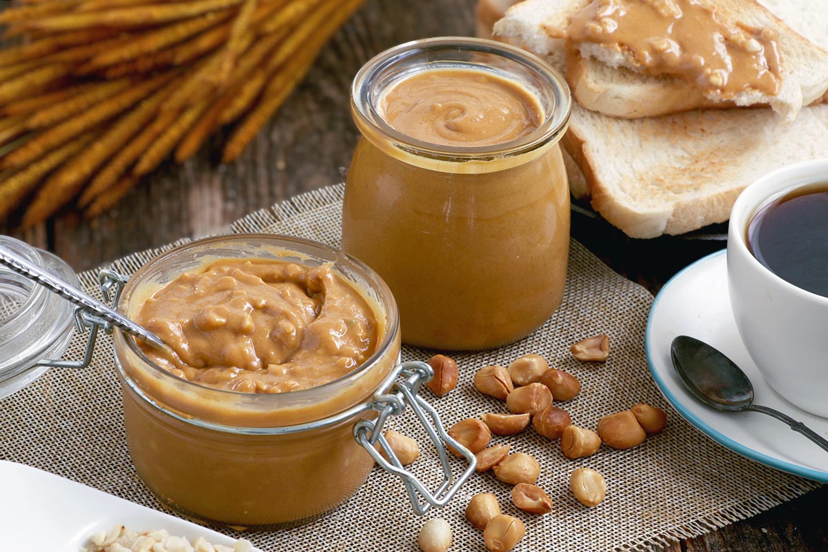 Homemade creamy Peanut Butter in jars.