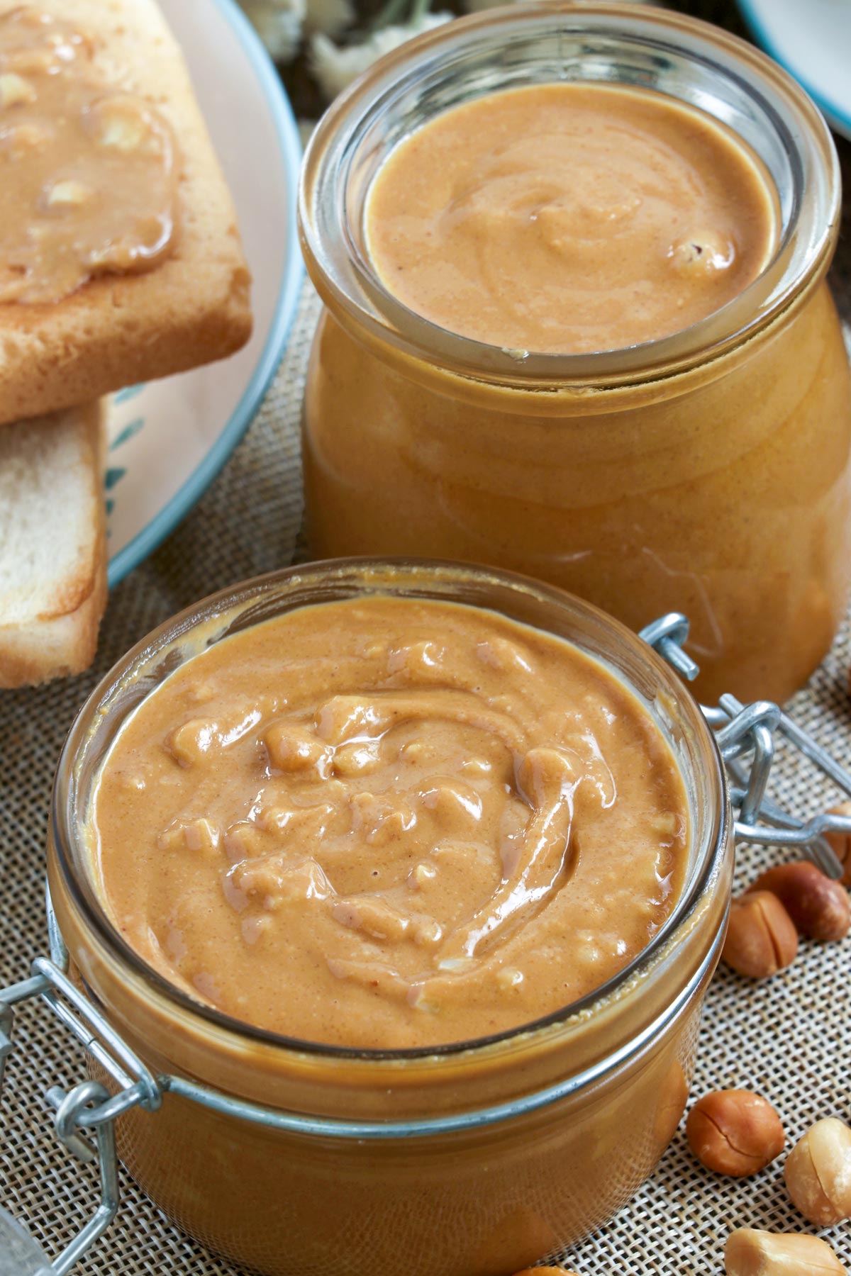 Chunky or smooth creamy homemade Peanut Butter in jars.