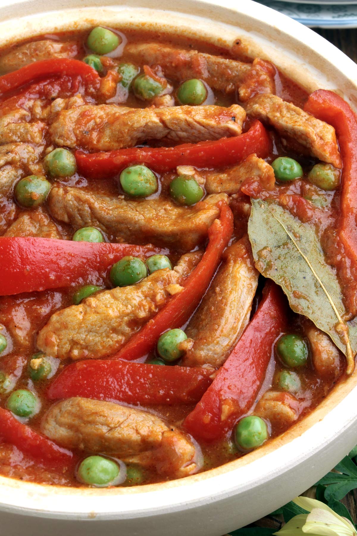 Pork strip in tomato-based stew with green peas.