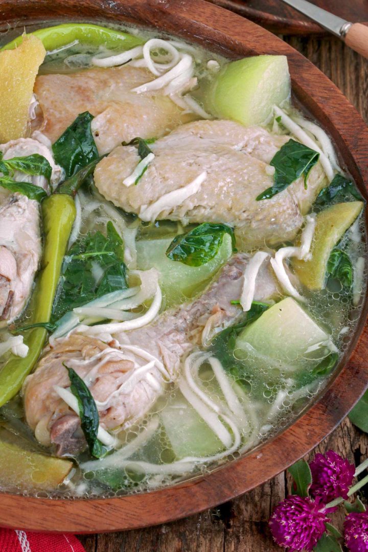 A bowl of Chicken Binakol soup with chayote, chili and coconut strings.