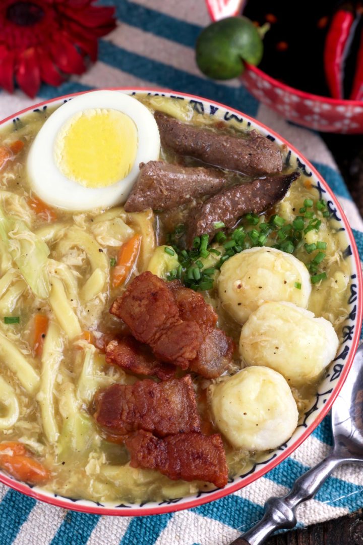 Pancit Lomi is a tasty and hearty egg-noodle soup topped with flavorful toppings.