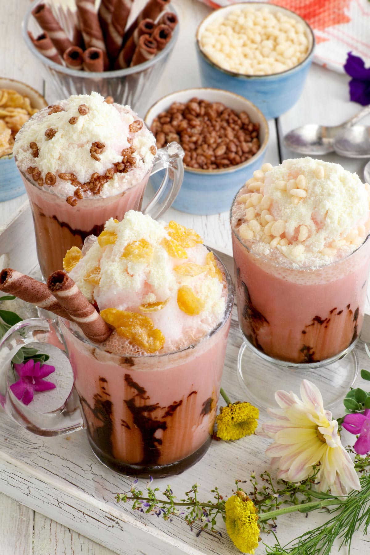 Banana-flavored and pink-hued Ice scramble in glasses with various toppings.