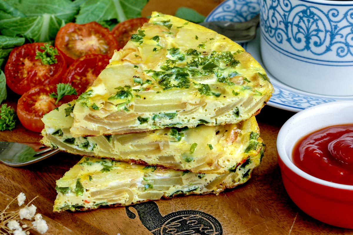 Slices of Potato Frittata stacked on a serving platter.