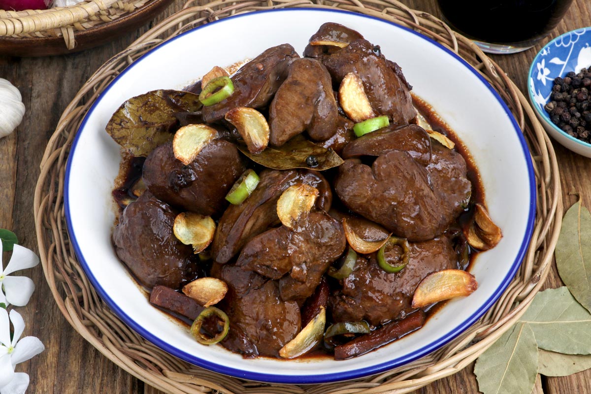 Adobong Atay ng Manok in a serving platter garnished with fried garlic slivers.